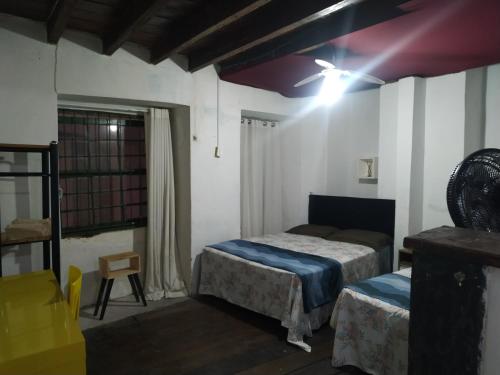a bedroom with two beds and a light on the ceiling at No coração do Pelourinho, perto de tudo. in Salvador
