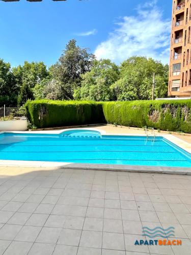 a swimming pool in the middle of a building at APARTBEACH SANCHO ABARCA CENTRICO y JUNTO PLAYA in Salou