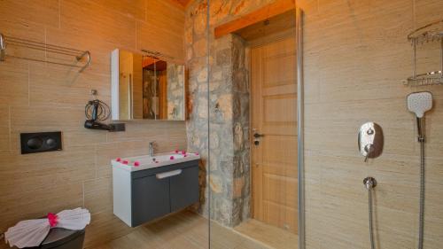 a bathroom with a sink and a shower at VİLLA VAVEYLA in Oludeniz
