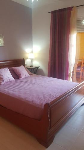 Un dormitorio con una cama grande con sábanas moradas y una ventana en Los olivos apartamento, en Vera