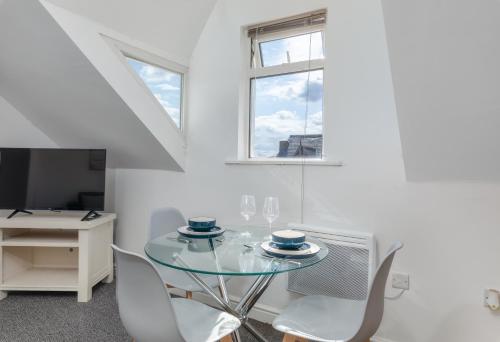 a dining room with a glass table and chairs at Thornhill House in Hartlepool