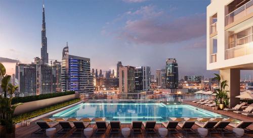 a swimming pool on top of a building with a city skyline at Downtown Ultra Luxury 1BR - 15 Northside - Burj Khalifa View in Dubai