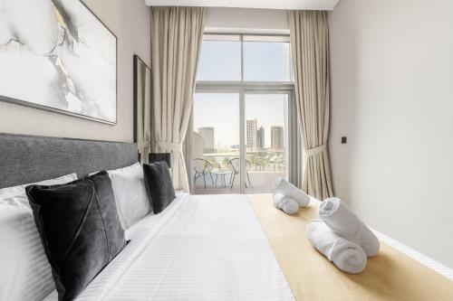 a bedroom with a large bed with towels on it at Downtown Ultra Luxury 1BR - 15 Northside - Burj Khalifa View in Dubai