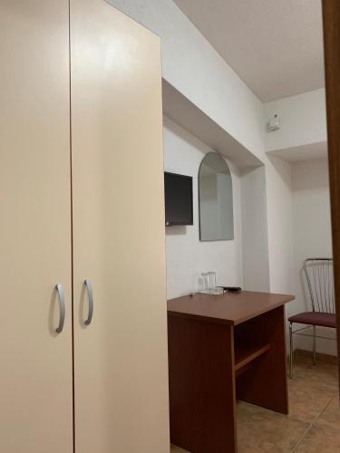 a room with a table and a desk with a mirror at Royal L Hotel in Carev Dvor