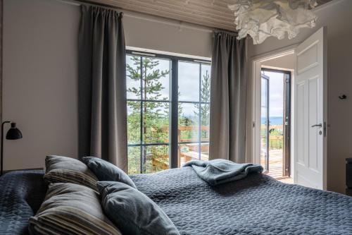 a bedroom with a bed and a large window at Idre Himmelfjäll Resort in Idre