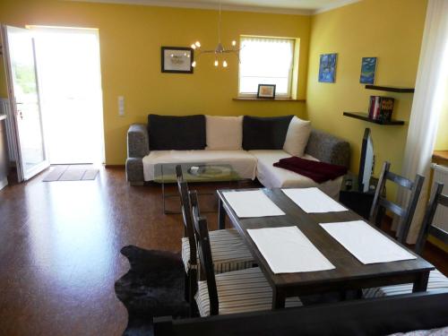 a living room with a couch and a table at Ferienwohnungen im Womoland auf No in Nordstrand