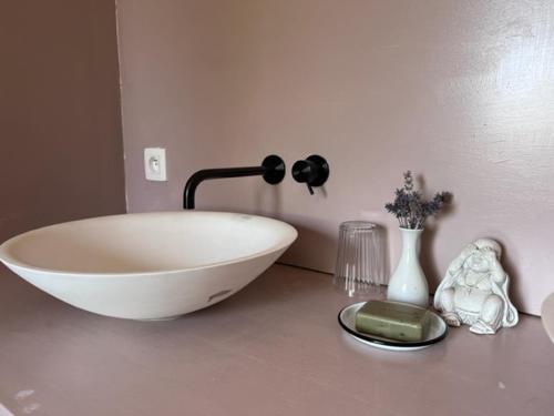 a bathroom with a white bowl sink on a counter at 't Schaaphof Tent en Ontbijt in Deinze