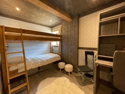 a bedroom with two bunk beds and a desk at Appartement Samoëns, 3 pièces, 4 personnes - FR-1-624-85 in Samoëns