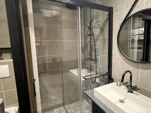 a bathroom with a shower and a sink and a mirror at Appartement Samoëns, 3 pièces, 4 personnes - FR-1-624-85 in Samoëns
