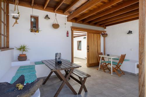 a room with a wooden table and a table and chairs at Casa El Patio Teseguite in Teseguite
