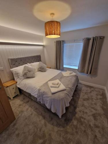 a bedroom with a bed with two towels on it at Sunny Side Tropical Hideaway in Cromer