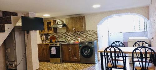 a kitchen with a stove and a dishwasher at GERGETI Arsenas Guest House in Kazbegi