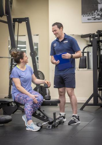 a man standing next to a woman in a gym at Slieve Russell Hotel in Ballyconnell