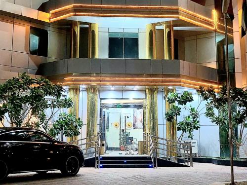 a black car parked in front of a building at Address Sharurah Hotel in Sharurah