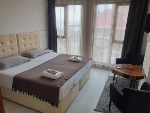 a bedroom with a bed with two towels on it at Sıla Apart Otel in Bostancı