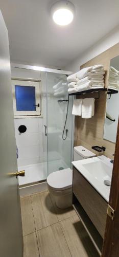 a bathroom with a toilet and a sink at Hotel y Cabañas Las Mellizas - Caja Los Andes in Los Ángeles