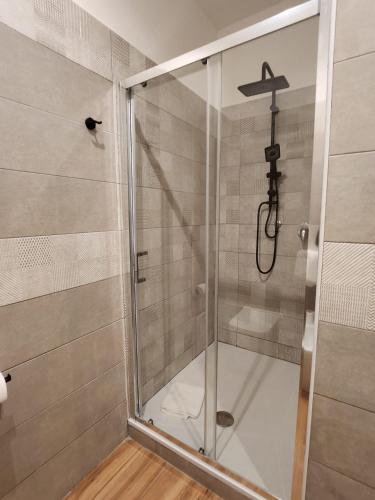 a shower with a glass door in a bathroom at B&B Mini Hotel Incity-close train station and port- in Salerno