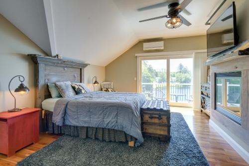 a bedroom with a bed and a large window at Waterfront Conway Area Condo Walk to Beach! in Silver Lake