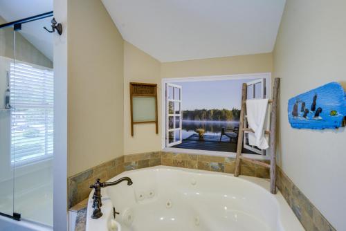 a bath tub in a bathroom with a window at Waterfront Conway Area Condo Walk to Beach! in Silver Lake
