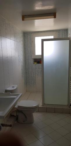 a bathroom with a toilet and a sink and a mirror at Appartement S+2 in Sousse