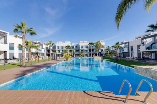 an image of a swimming pool at a resort at Oasis Beach XII - Casa Lotus in Guardamar del Segura