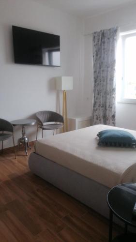 a bedroom with a bed and a desk and a window at B&B Mini Hotel Incity-close train station and port- in Salerno
