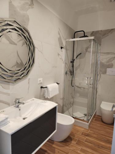 a bathroom with a shower and a sink and a toilet at B&B Mini Hotel Incity-close train station and port- in Salerno