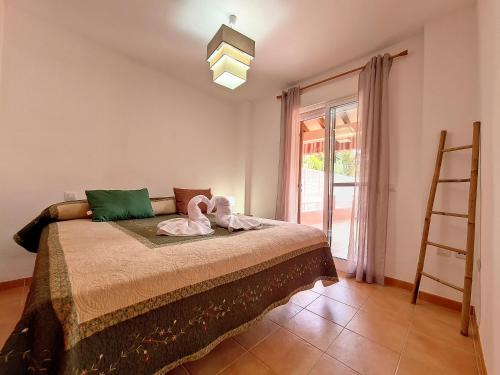 a bedroom with a bed with a ladder and a window at Albatros Playa 1 - 9609 in Mar de Cristal