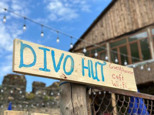 a wooden sign for a dipo hit in front of a building at Guesthouse Divo Hut in Ushguli