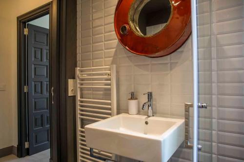 a bathroom with a sink and a mirror on the wall at Villa Margarita in Palma de Mallorca