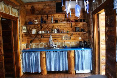 a kitchen with a blue counter top in a cabin at Estate - Villa Discovery in Ljubuški