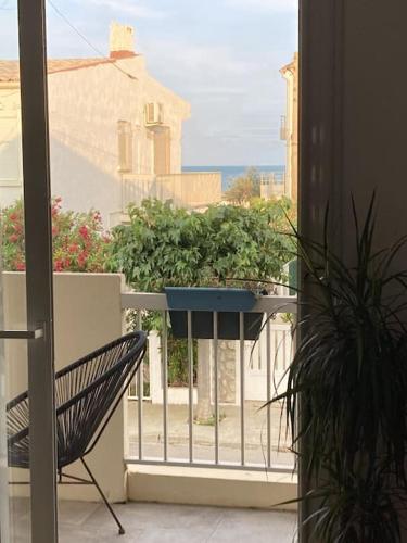 un balcon avec un banc et une jardinière sur un balcon dans l'établissement Direction Sud !, à Narbonne-Plage