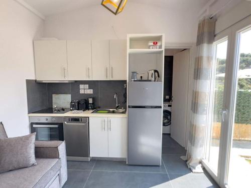 a kitchen with a stainless steel refrigerator in a room at Villa Amaryllis in Meganisi