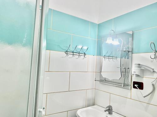 a bathroom with a shower and a sink at Hotel Asteri in Velipojë