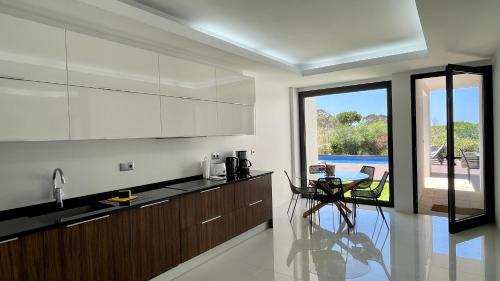 a kitchen with a counter and a table with chairs at Passion by Check-in Portugal in Albufeira