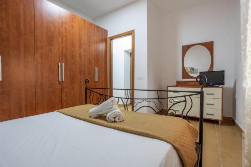 a bedroom with a bed and a dresser and a mirror at Casa Vacanze Cappuccini in Palermo
