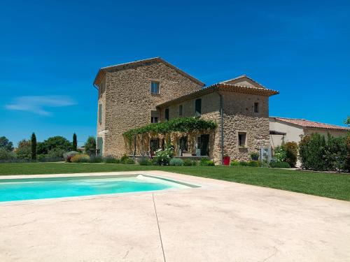 a house with a swimming pool in front of it at Les Oliviers De Notre Dame in Mazan