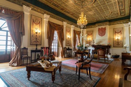 a large living room with a chandelier and a ceiling at Hotel Boutique Santa Lucia in Cuenca