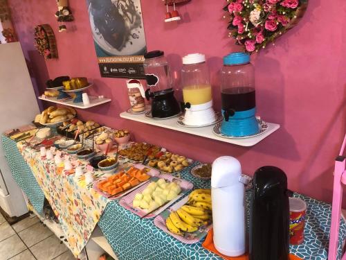 a table with a buffet of food and drinks at Pousada Chuá Chuá in Conservatória