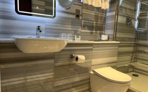 a bathroom with a sink and a toilet at Warren House Hotel in Kingston upon Thames