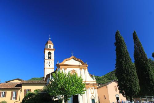 a building with a clock tower in front of a building at Casa Mia Apartment in Bellagio