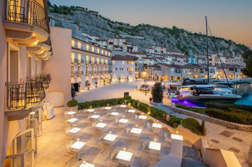 a view of a hotel with a marina at night at Tivoli Portopiccolo Sistiana Wellness Resort & Spa in Sistiana