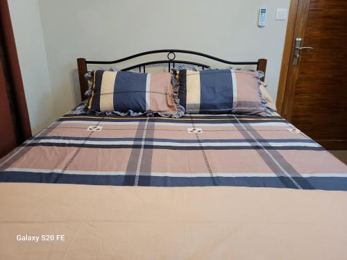 a bed with two pillows on top of it at Pearl Gate Residence, Aprt no2 in Flic-en-Flac