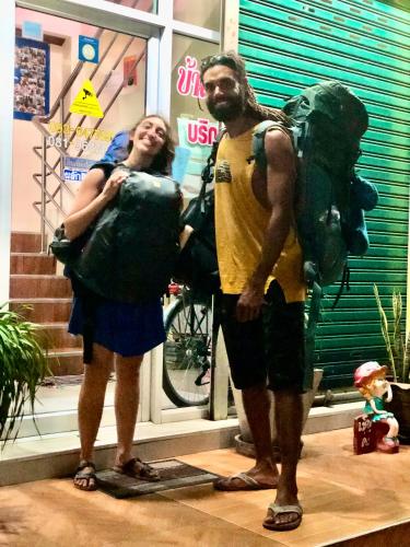 a man and a woman standing in front of a store at Baansrisuthum in Don Sak