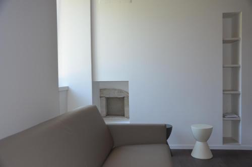 a living room with a couch and a fireplace at Palazzo Oltre in Arco