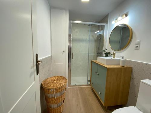 a bathroom with a shower and a sink and a mirror at Isabella Center Boutique in Toledo