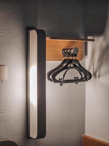 a light hanging on the side of a refrigerator at ibis budget Rio de Janeiro Centro in Rio de Janeiro