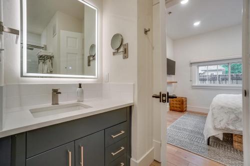 a bathroom with a sink and a mirror at Old Town Carriage House with Private Patio in Fort Collins