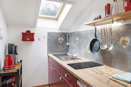 a kitchen with a sink and a counter top at Aschaubichl - Wohnung Anemone in Grainau