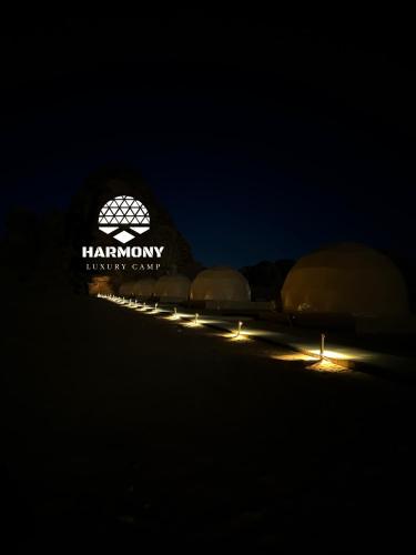 a building with a harium energy center lit up at night at Harmony Luxury Camp in Wadi Rum